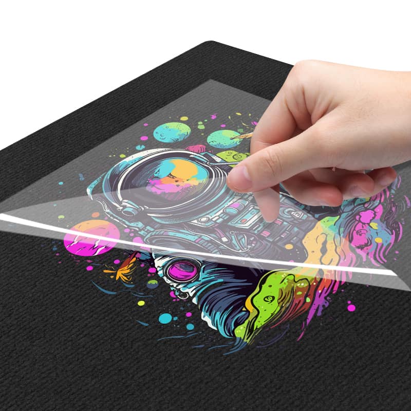 Peeling a vibrant DTF transfer off a black shirt